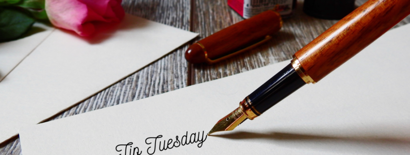 Old-style ink pen writing "Tip Tuesday" on paper