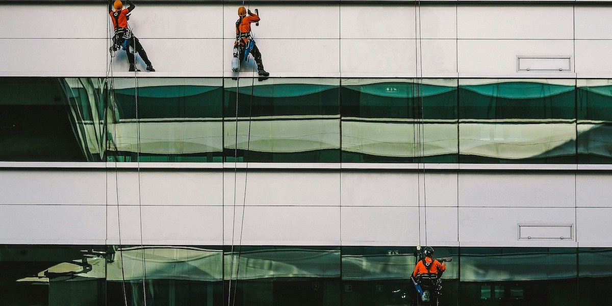 Men washing windows representing ghostwriting being the solution to clarity